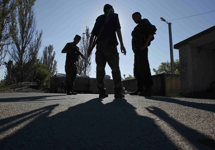 Pro-Russian separatists stand guard on a street in the eastern Ukrainian town of Ilovaysk