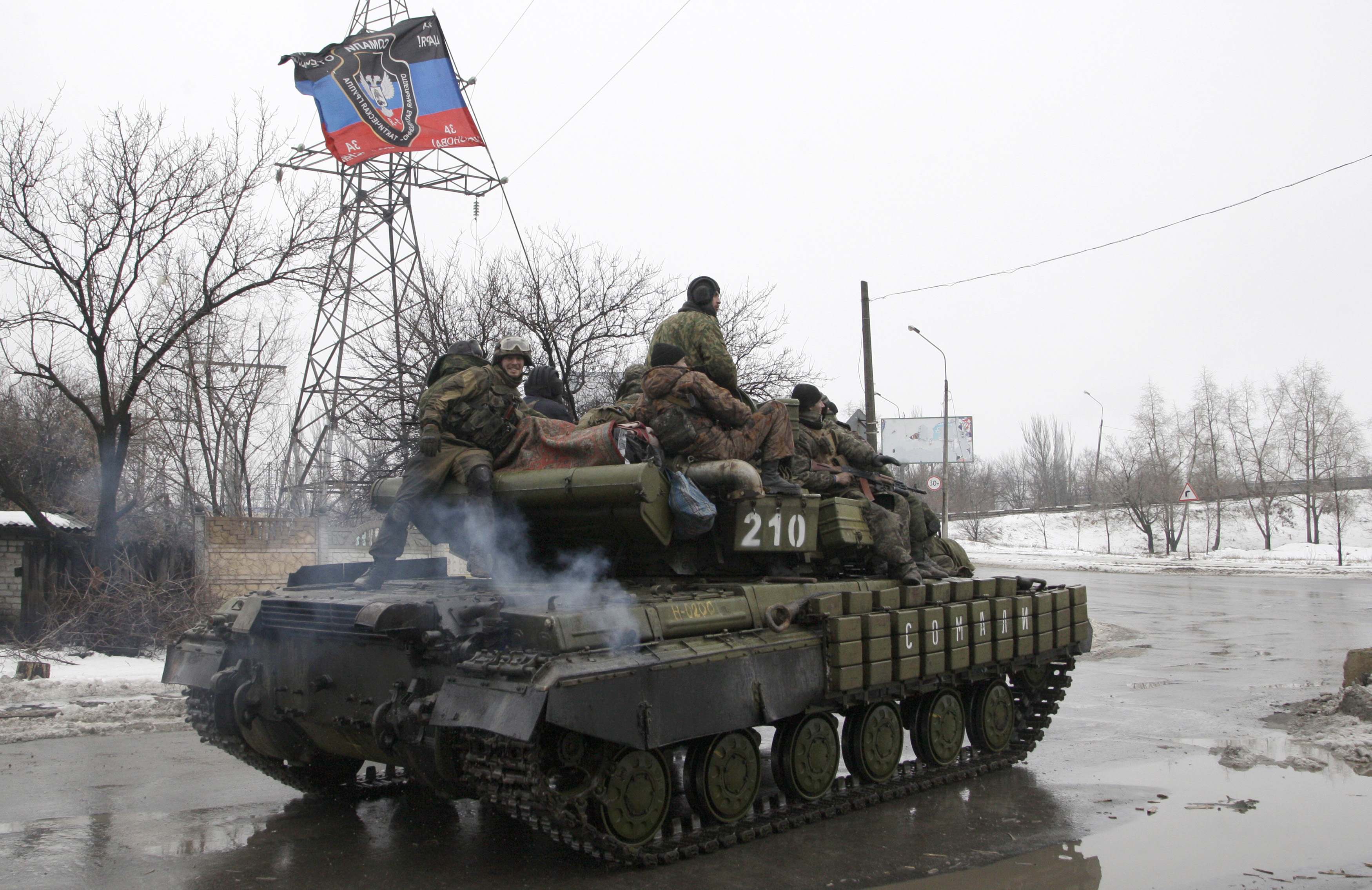 Members of the armed forces of the separatist self-proclaimed Donetsk People's Republic drive an armoured vehicle on the outskirts of Donetsk