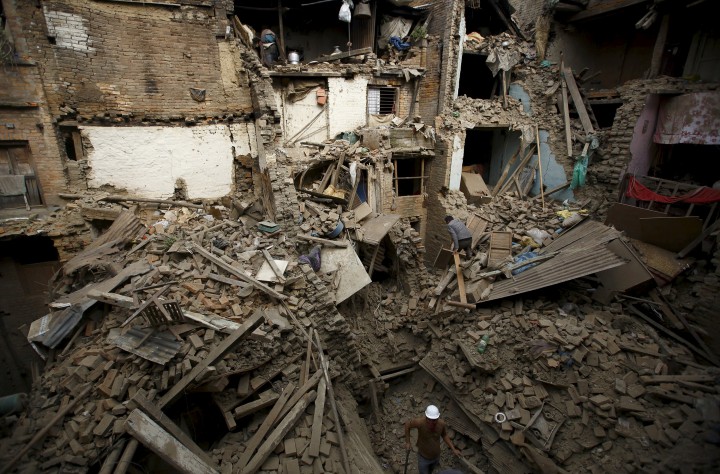 People search for family members trapped inside collapsed houses a day after an earthquake in Bhaktapur