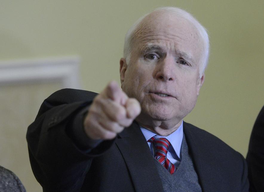 U.S. Senator McCain gestures as he speaks to journalists during a news conference in Kiev