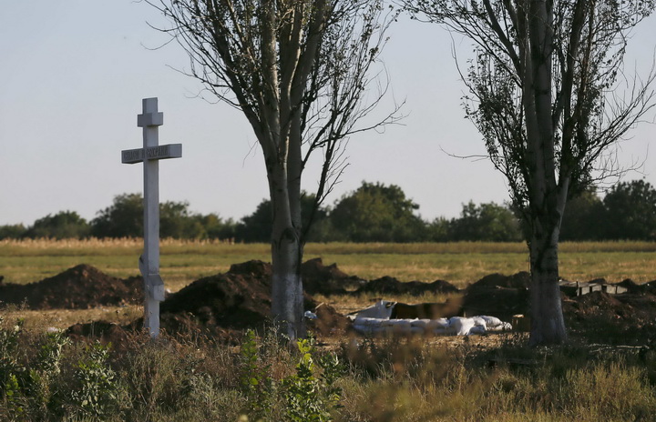 A cross stands at an abandoned Ukranian military position after fighting with pro-Russian separatists outside the village of Mnogopolye, southeast from Donetsk