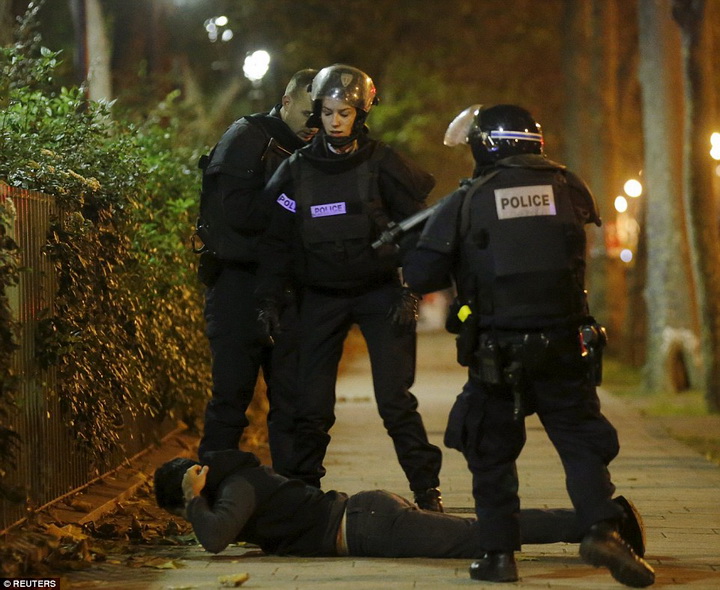 2E6CF2F700000578-3317776-A_man_lies_on_the_ground_as_French_police_check_his_identity_nea-m-50_1447461215203