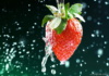 Strawberry On A Green Background With Drops Of Water